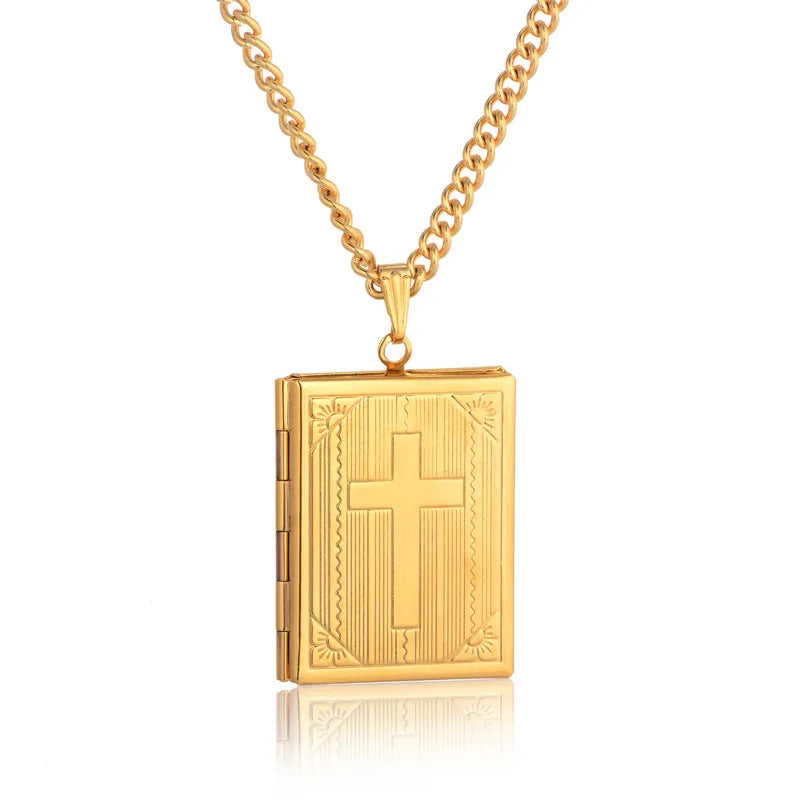 Gold necklace with a bible pendant featuring a cross on a white background