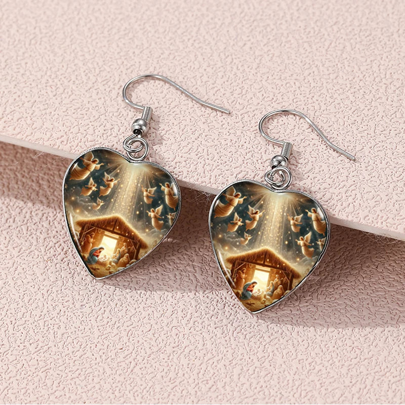 Heart-shaped earrings with a winter scene design on a pink background