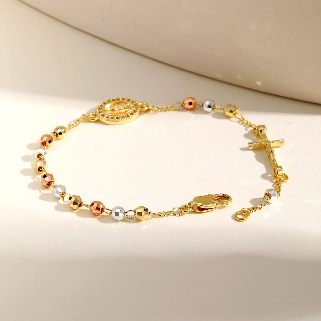 Gold bracelet with multicolored beads on a beige background