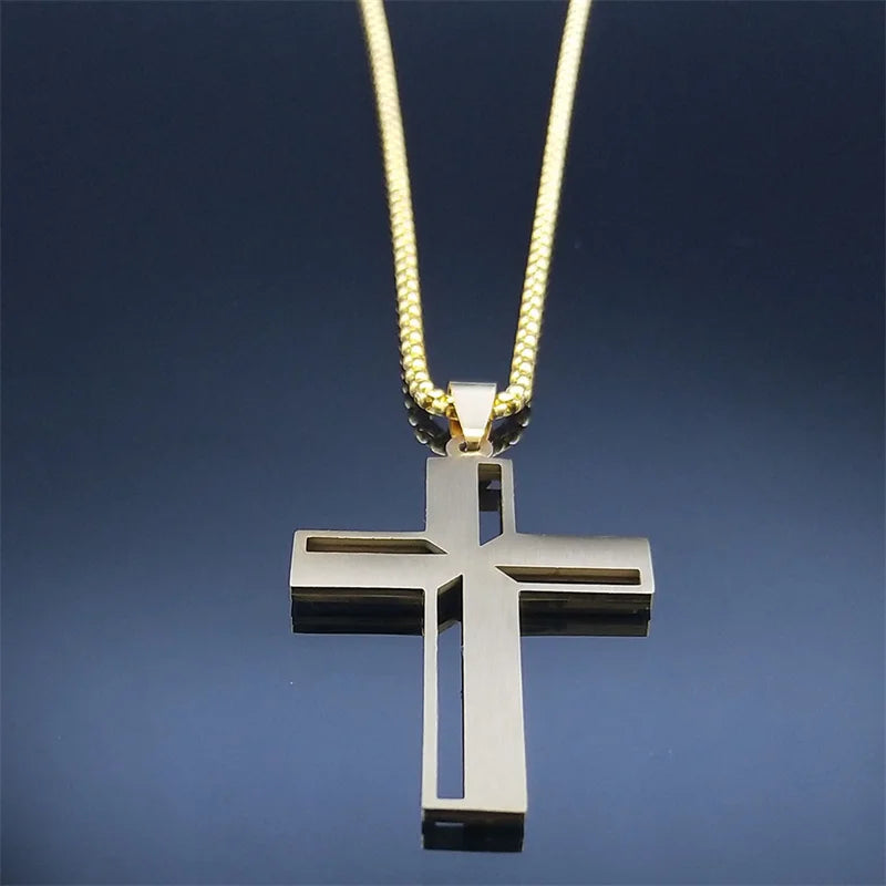 Silver cross pendant on a gold chain against a dark blue background