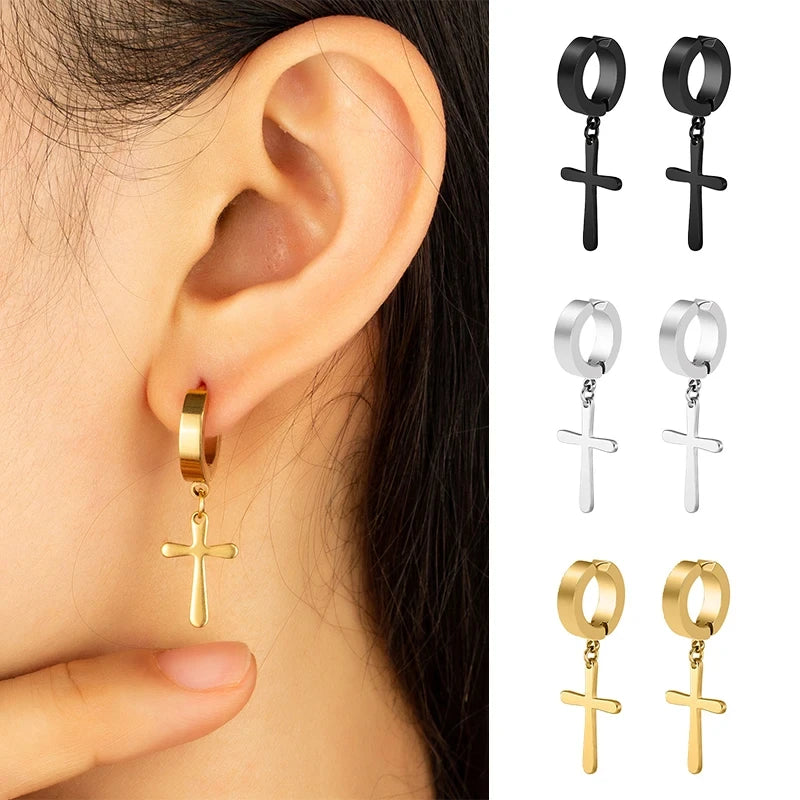 Gold hoop earrings with cross designs worn on an ear, with additional pairs displayed.