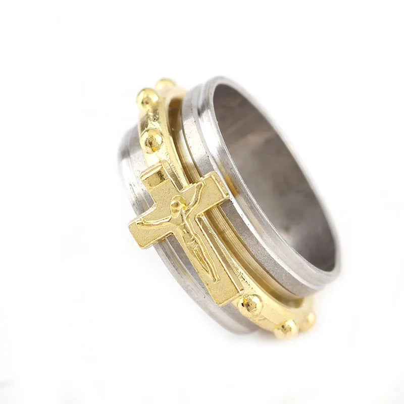 Two-tone ring with gold cross design on a white background