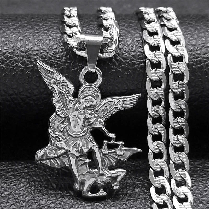 Silver angel pendant necklace on a textured surface