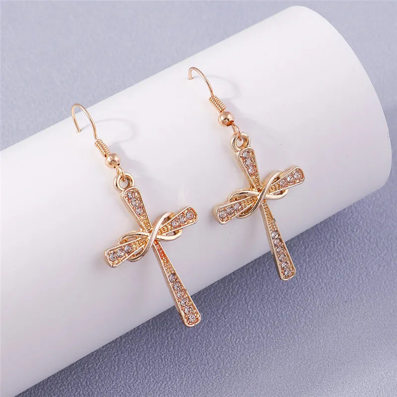 Rose gold bow-shaped earrings on a white and gray background