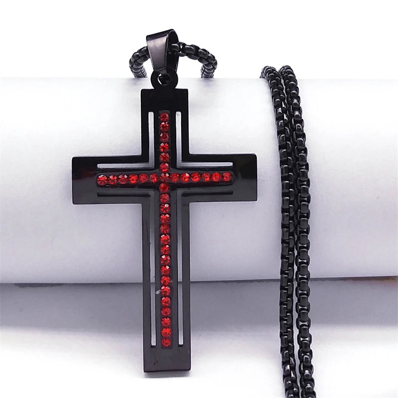 Black cross pendant with red stones on a black chain against a white background