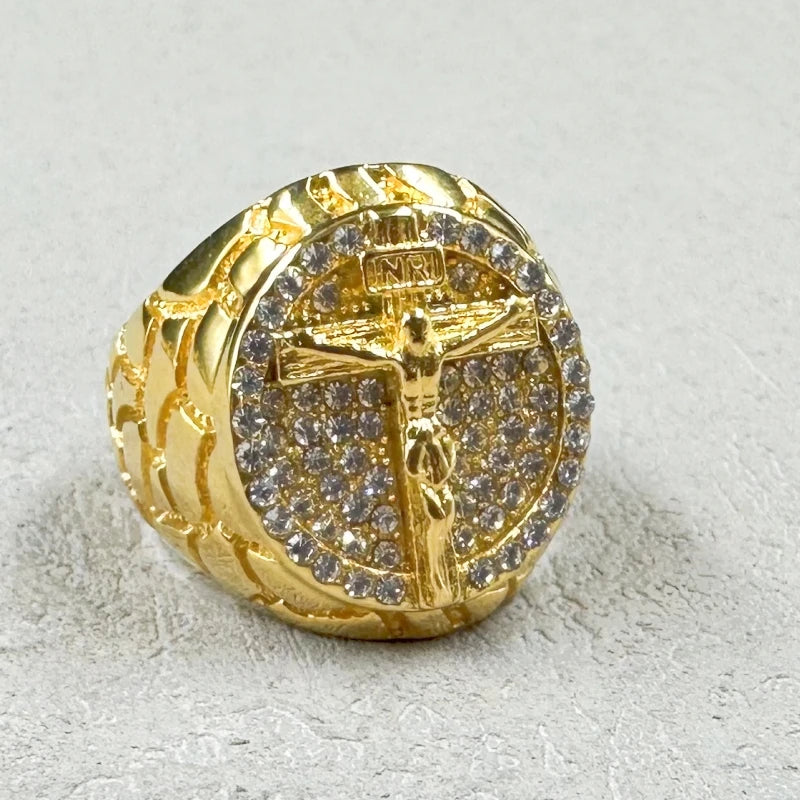 Gold ring with crucifix design on a light gray background