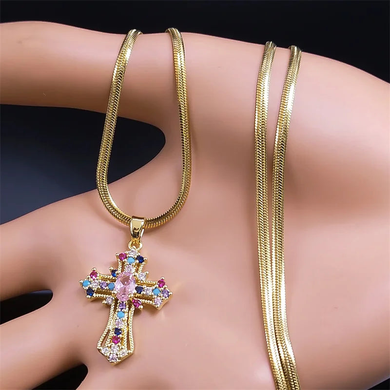 Gold necklace with a cross pendant featuring colorful gemstones on a mannequin.