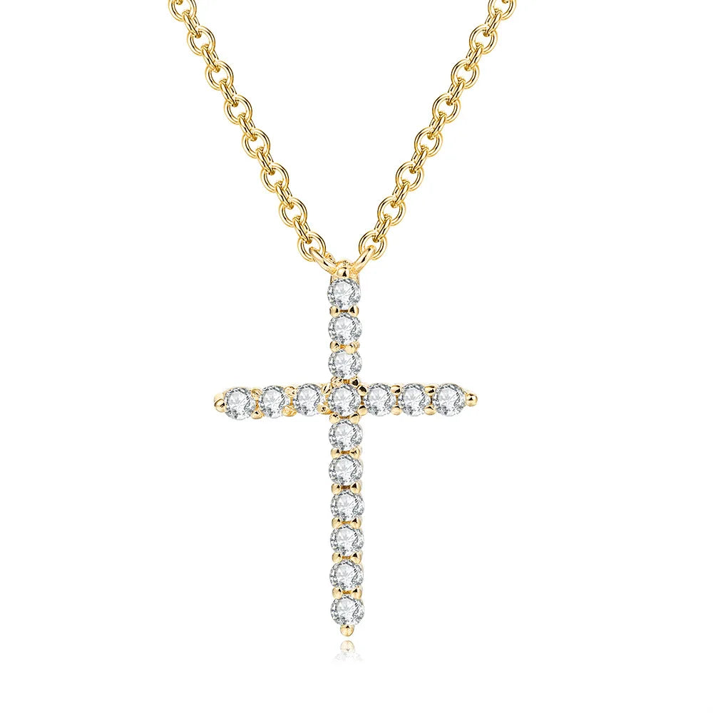 Gold cross necklace with clear stones on a white background
