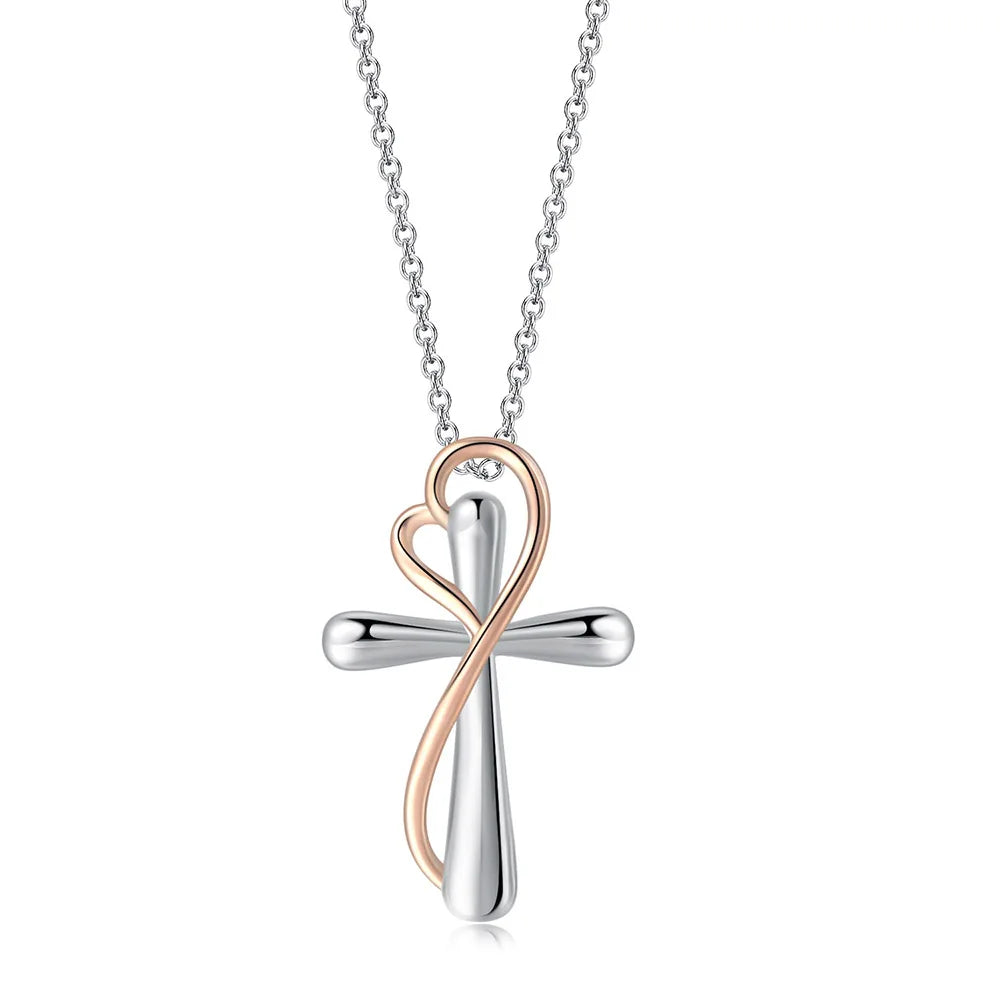 Two-tone cross necklace with heart detail on a white background