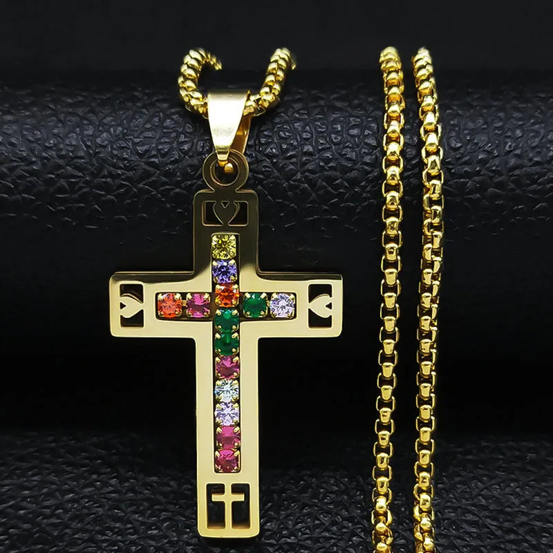 Gold colour cross pendant with colorful stones on a gold chain against 