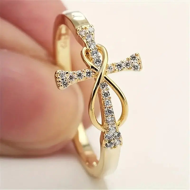 Gold ring with diamond accents on a blurred background