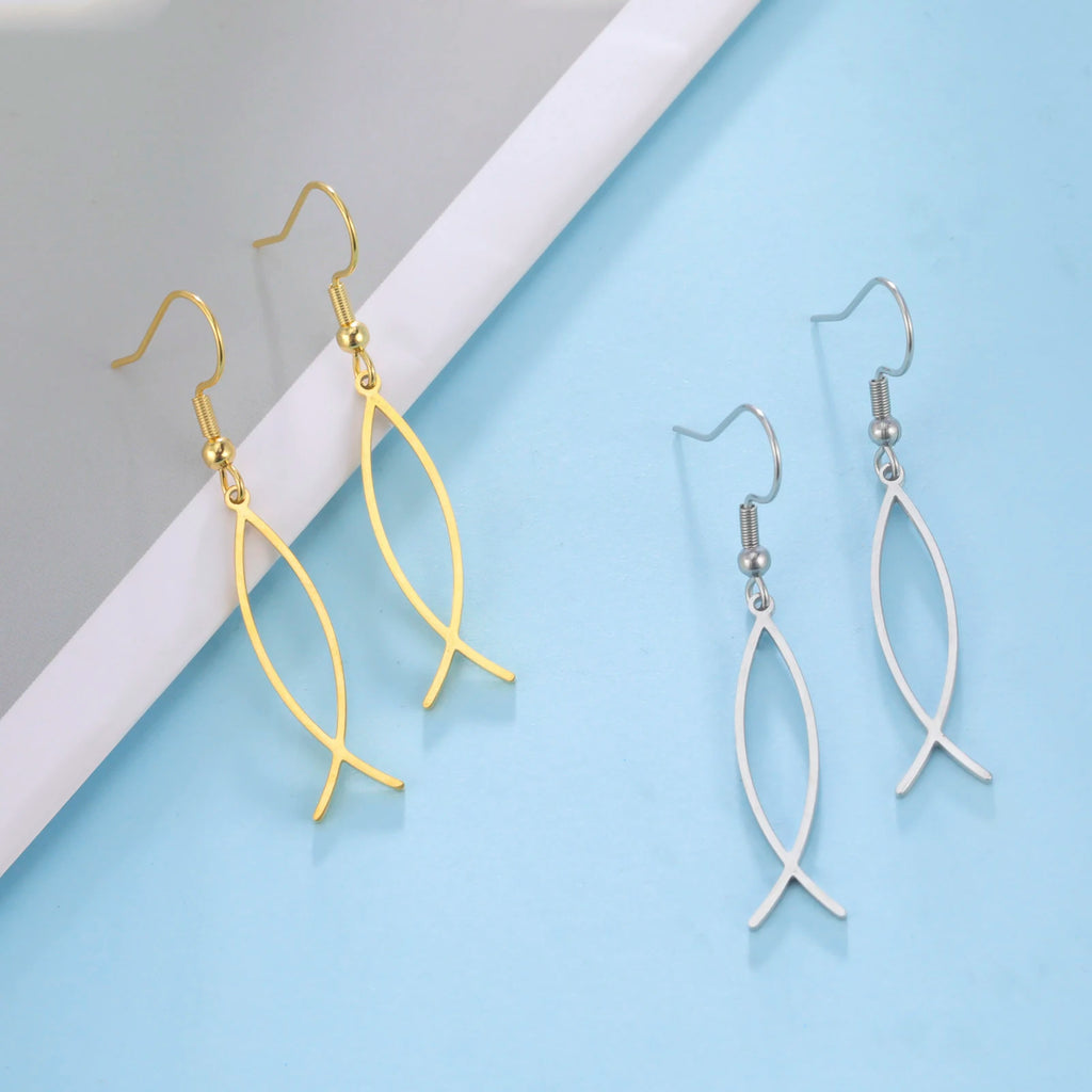 Gold and silver leaf-shaped earrings on a light blue and gray background