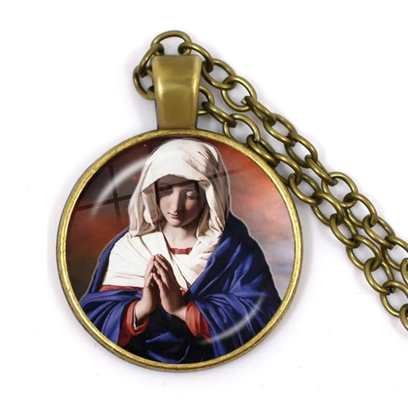 Pendant with a religious design of a woman in a blue robe on a white background
