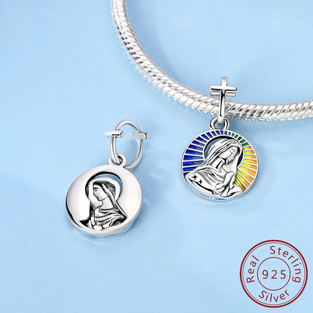 Silver Virgin Mary pendant and bracelet on a light blue background with 'Real Sterling Silver 925' stamp.