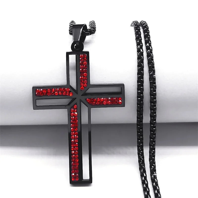 Black cross pendant with red stones on a white background