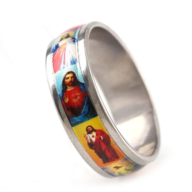 Stainless steel ring with religious-themed design on a white background
