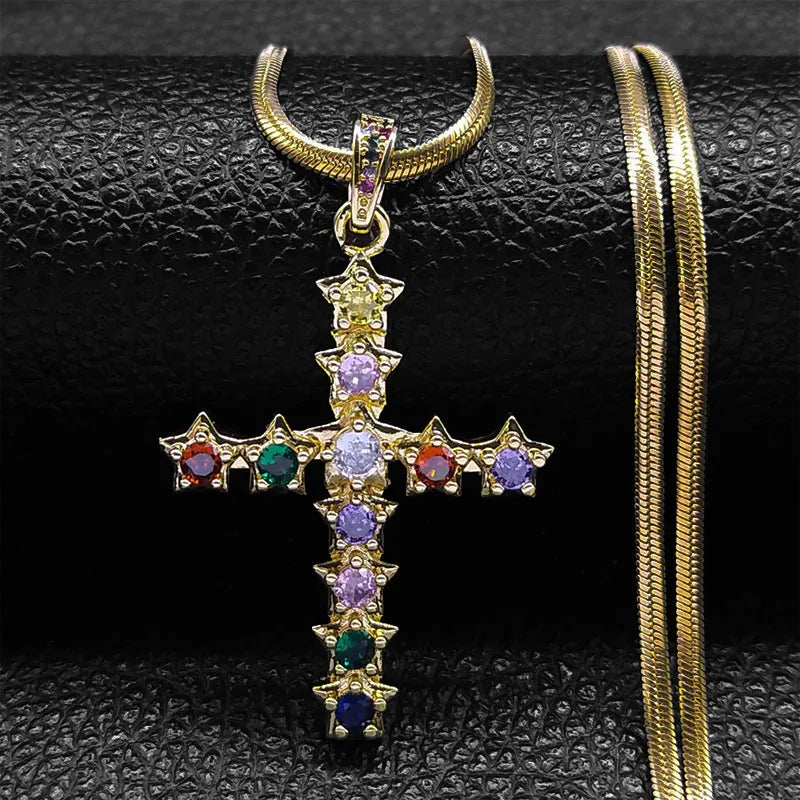 Gold cross pendant with colorful gemstones on a black textured background
