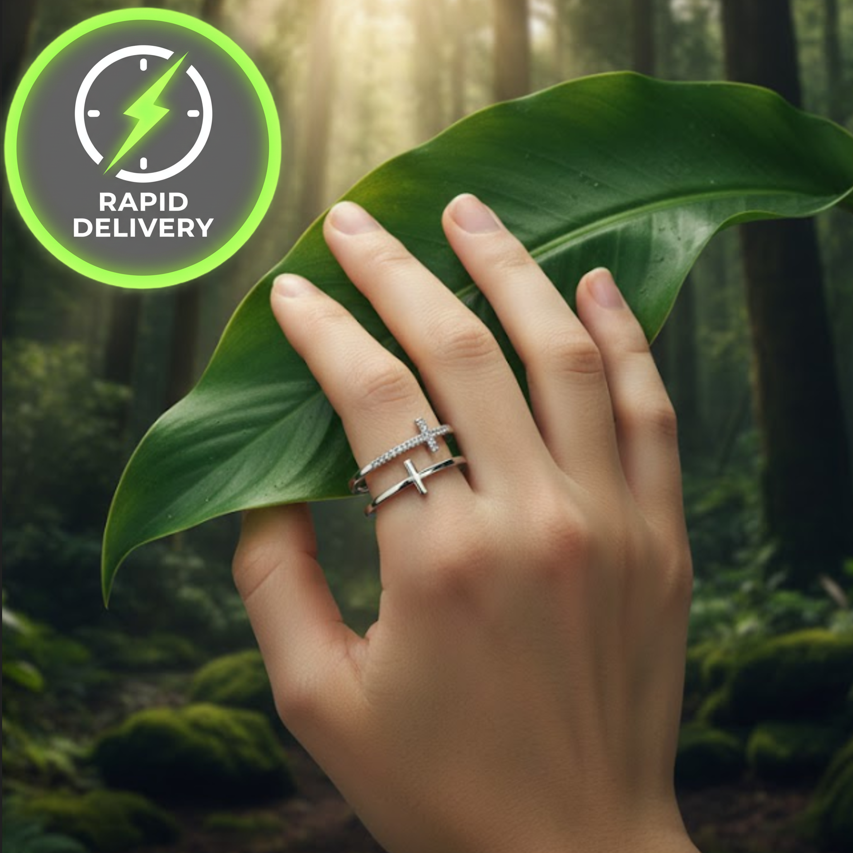 Silver double band open ring with cross designs, sound charged with a 'Rapid Delivery' icon in a forest setting