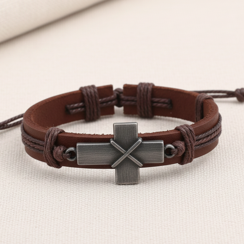 Brown leather bracelet with a silver cross pendant, sound-charged