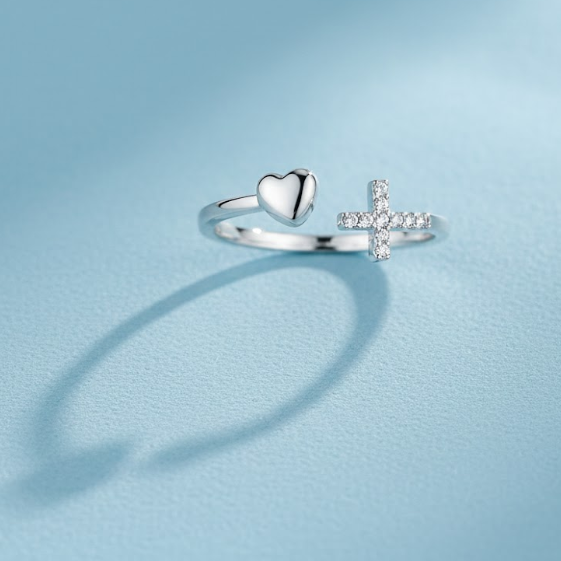 Close-up of the Trilogy of Grace Silver Heart Cross Ring, an adjustable stainless steel open-wrap ring featuring a heart symbol and a cross accented with zirconia crystals. Symbolic Christian Jewellery representing Faith, Love, and Hope, sound-charged with a 'Rapid Delivery' logo overlay, Australia, RuHa Spirit.