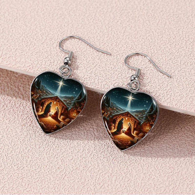 Heart-shaped earrings with a desert landscape design on a pink background
