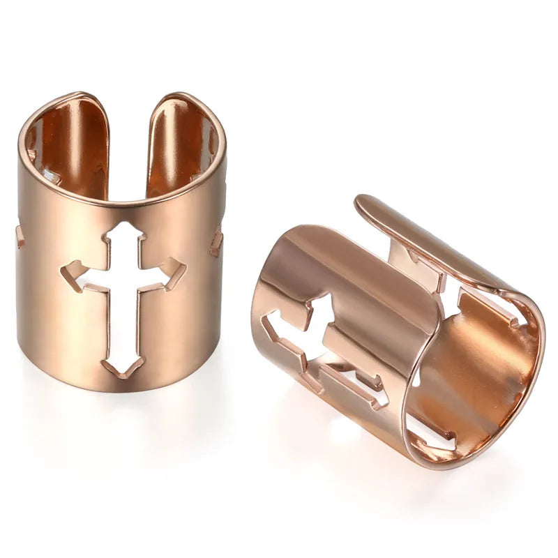 Rose gold cuff earrings with cross cutouts on a white background