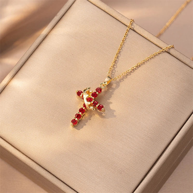 Gold necklace with red gemstones on a beige jewelry box