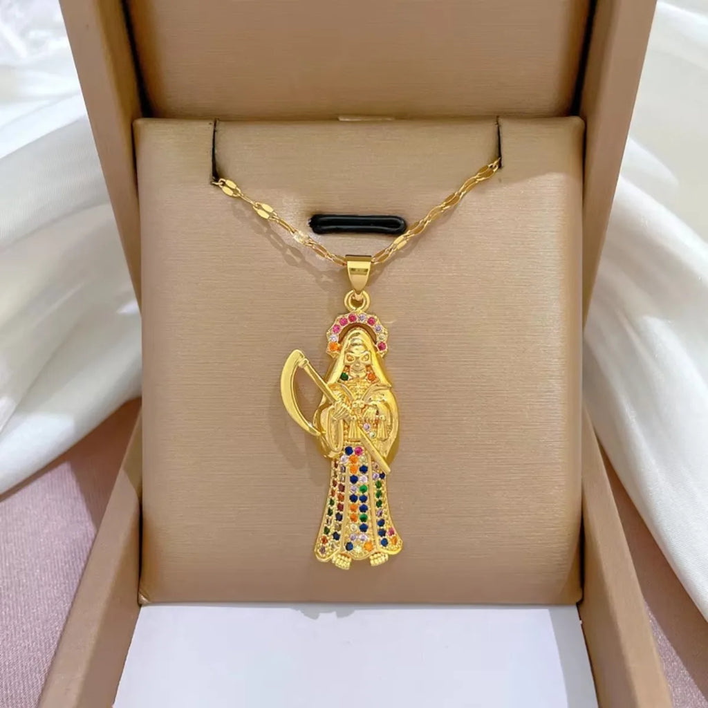 Gold pendant with colorful stones in a beige jewelry box