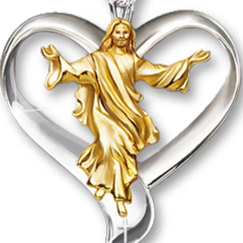 Gold figure of a religious figure inside a silver heart-shaped pendant on a white background