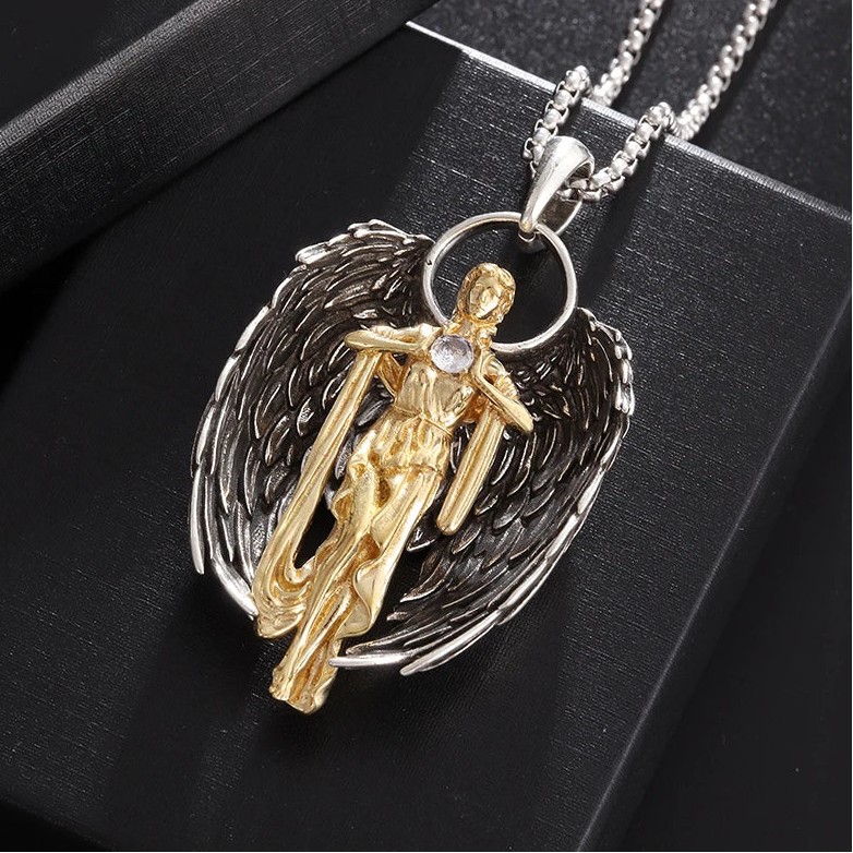 Gold and silver angel pendant on a black background