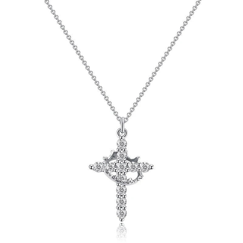 Silver cross pendant necklace on a white background