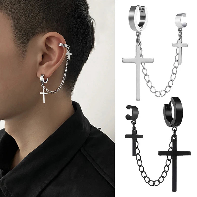Earring with cross and chain design worn by a person, with additional black and silver earrings shown.