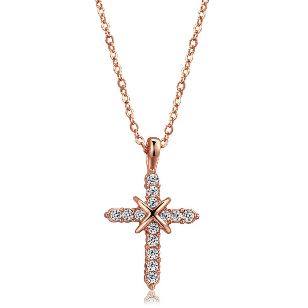 Rose gold cross pendant necklace on a white background