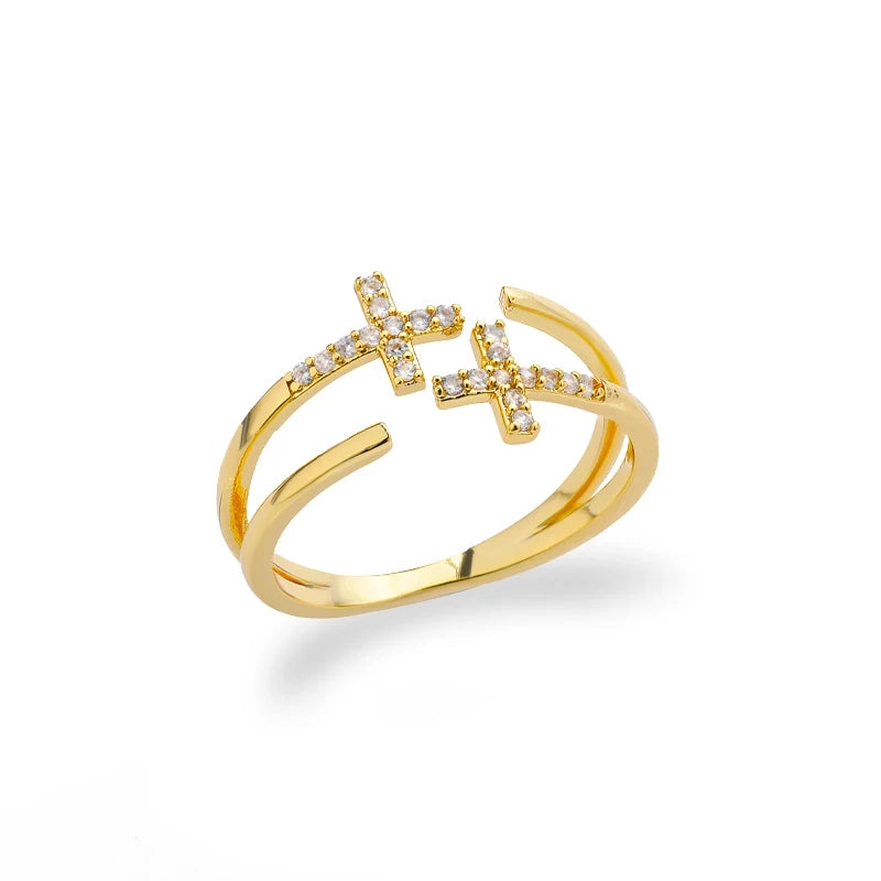 Gold ring with cross designs on a white background