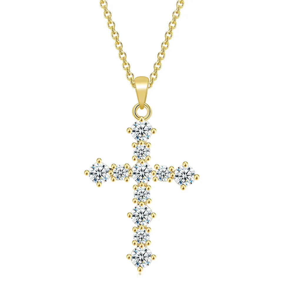 Gold cross pendant necklace with clear stones on a white background