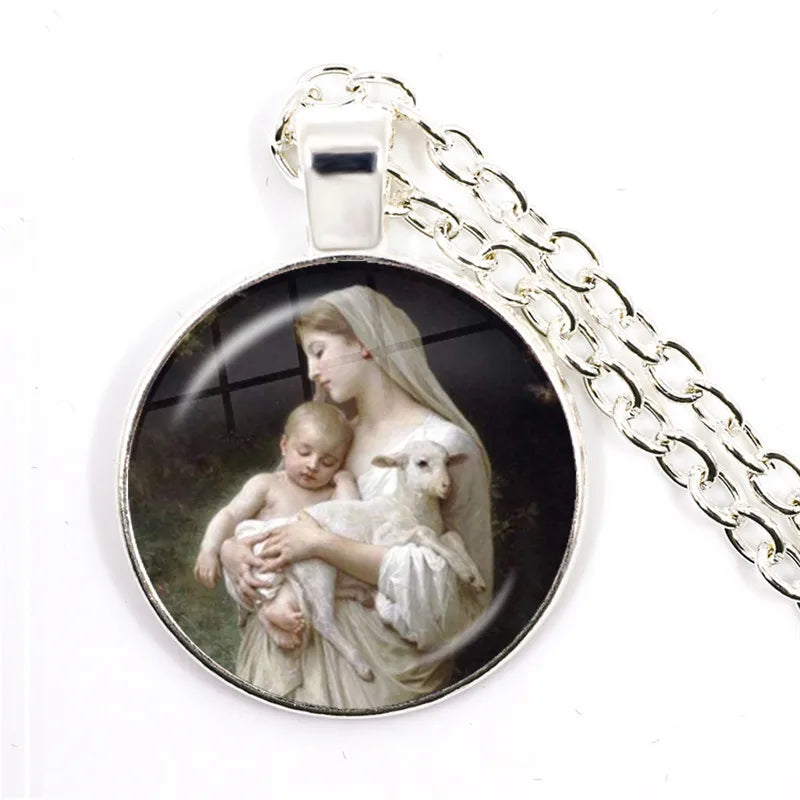 Pendant with a religious scene of a woman holding a child and a lamb, on a white background.