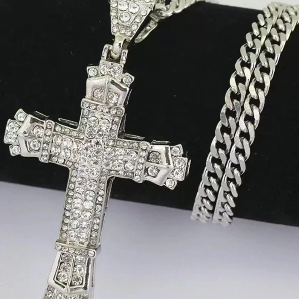 Silver cross pendant with chain on a black and white background