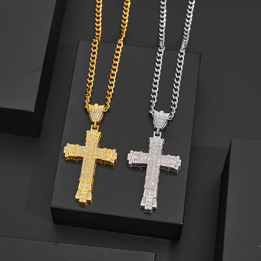 Two cross necklaces, one gold and one silver, on a black background.