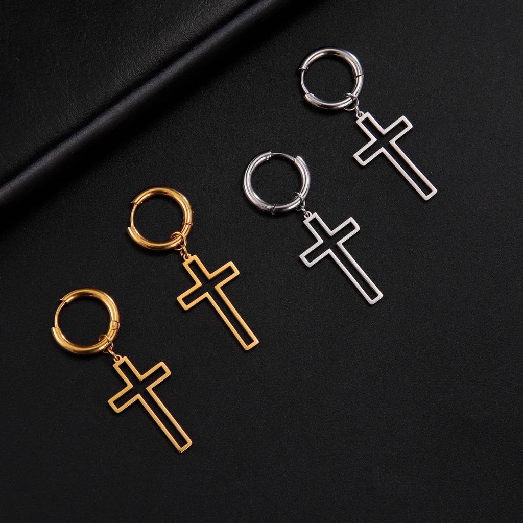Cross-shaped earrings in gold and silver on a black background