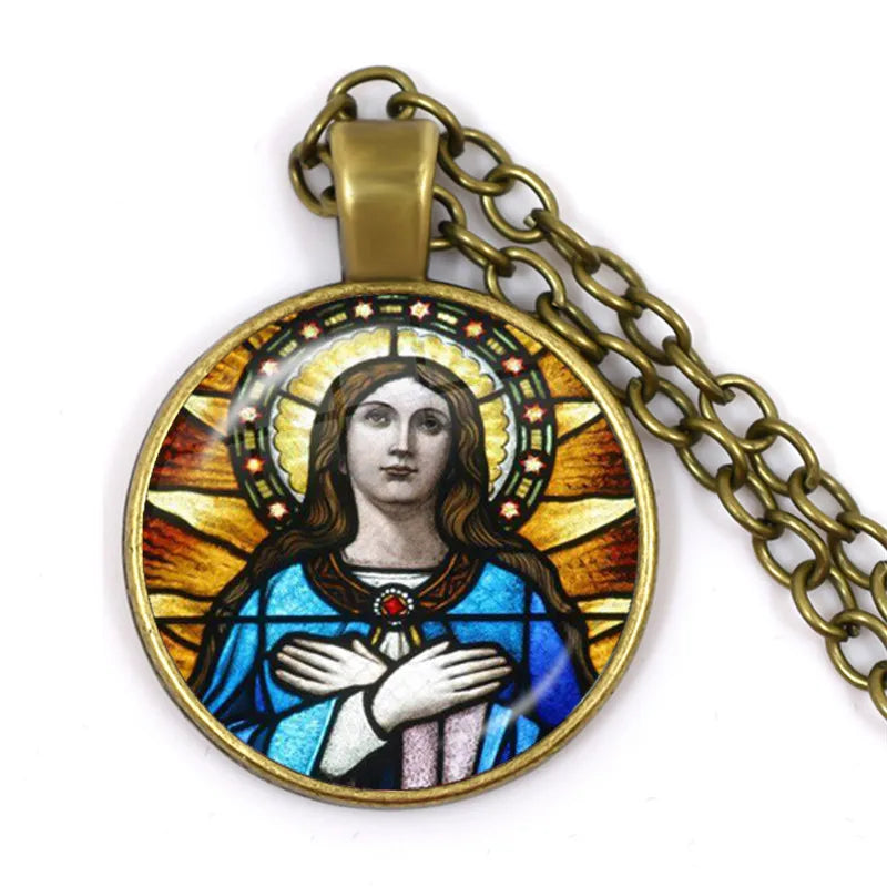 Pendant with religious design on a chain against a white background